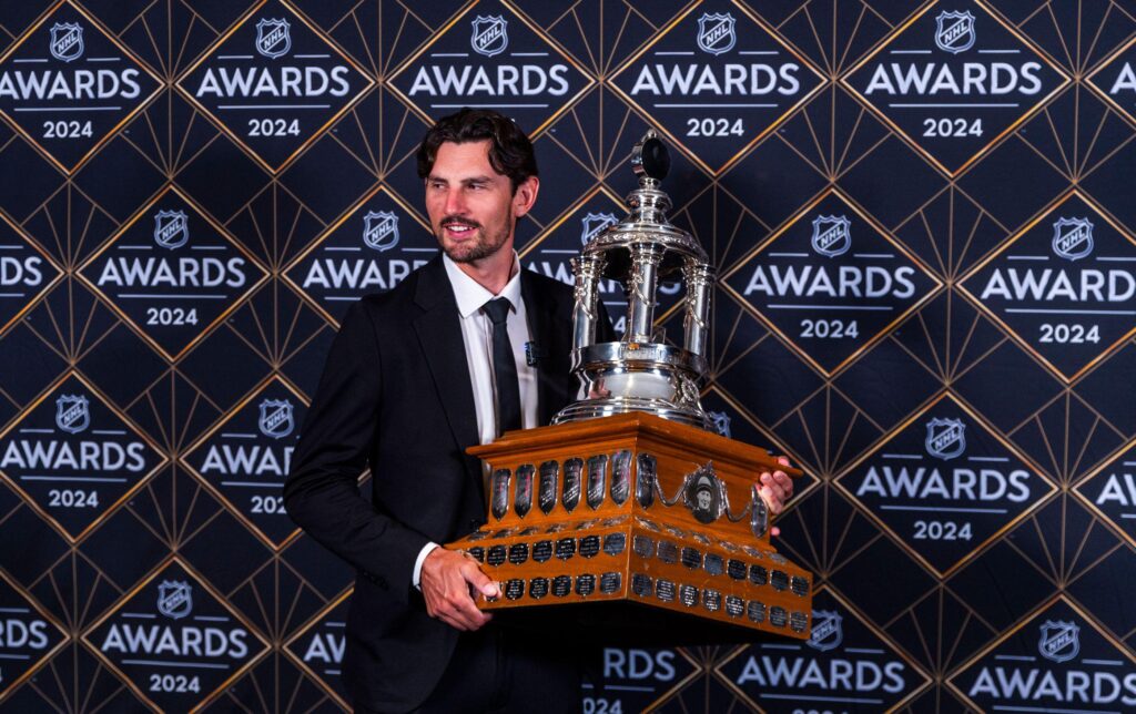 Connor Hellebuyck with the Vezina Trophy